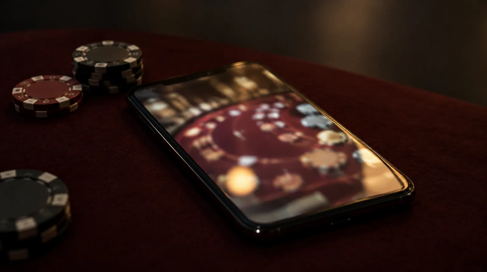 A smartphone on a felt table showing a live dealer stream